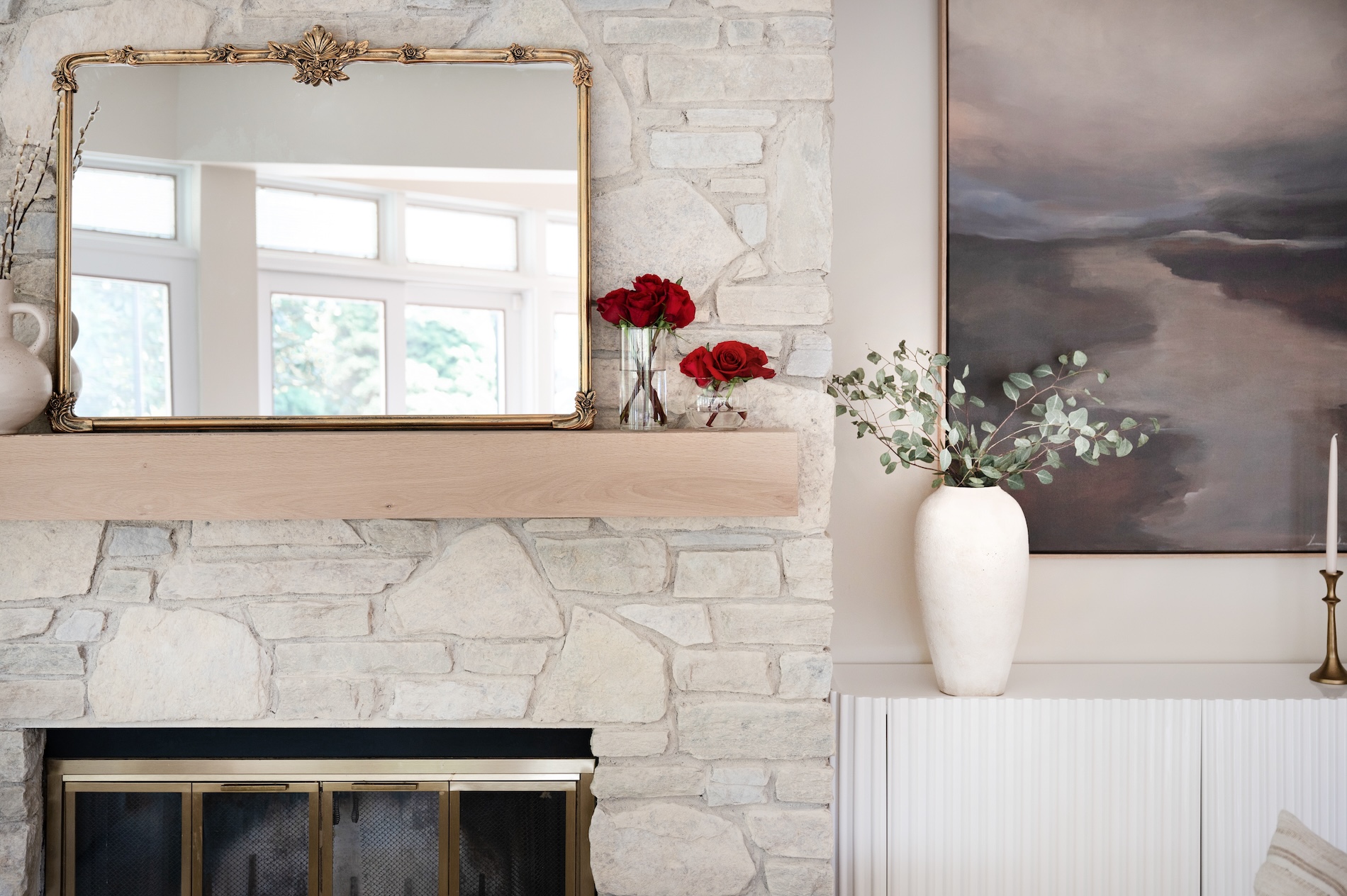 Stone Fireplace With Wood Mantel And Gold Mirror